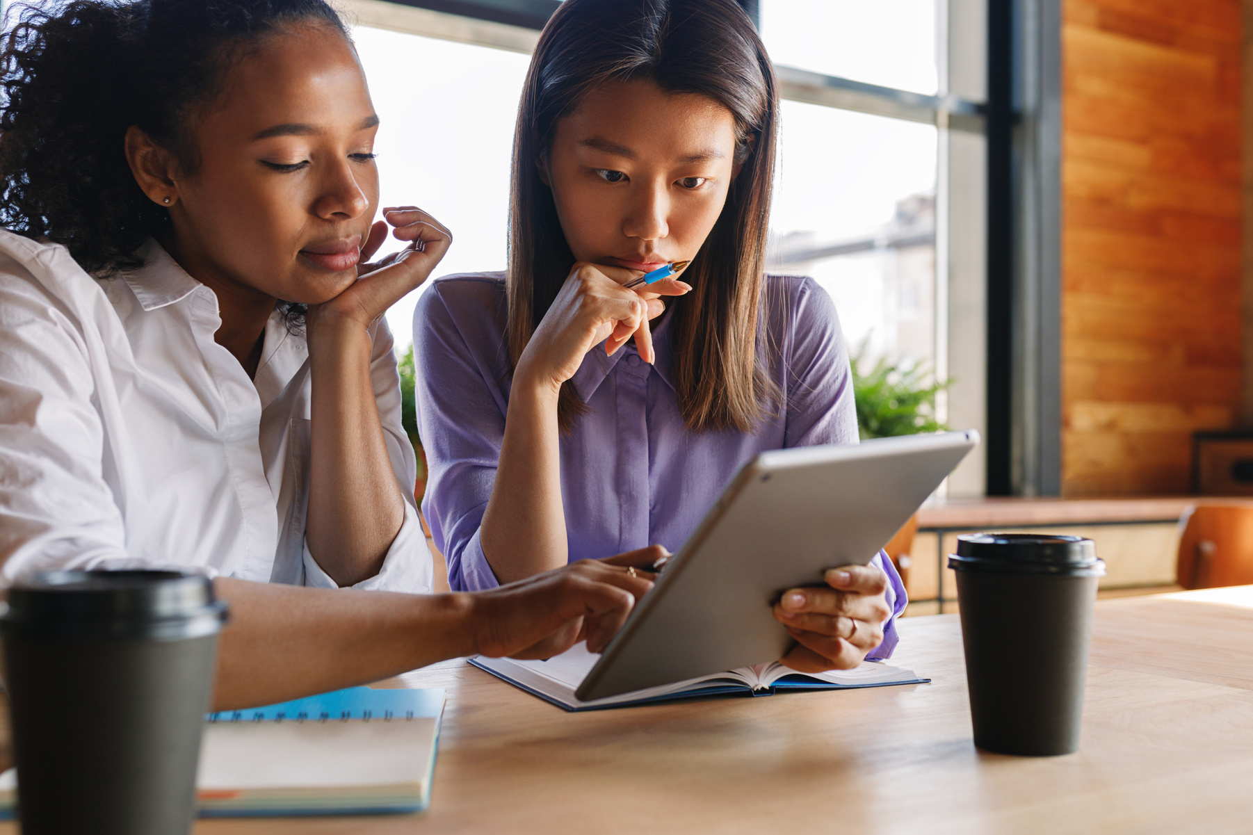 Women Studying and Using Tablet